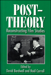Still image of Laurel and Hardy dressed as professors and writing on a chalkboard