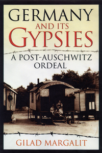 The cover of Germany and it Gypsies is brown, black and red, with a dark image of three Gypsy wagons.