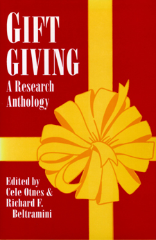 Cover of Gift Giving is red with a giant yellow bow in the center.