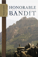 the cover of Honorable Bandit is based on a photo of a hiker in Corsica. A few rocky outcrops, a mountain and a small hiker. on the left is an olive-drab strap with a tag bearing the author's name.