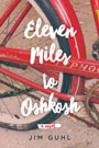 Eleven Miles to Oshkosh: Cover art of a close up picture of a red bicycle's back tire. The bike is on a dirt road. The title in written in a thick, curly, white font.