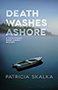Death Washes Ashore: the cover shows a picture of a lone canoe on a foggy lake, a forest at the water's edge. The title text is written in transparent white font at the top half of the page.