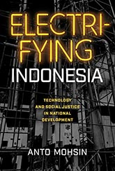 Electrifying Indonesia: a grayscale photo of interconnecting pipes and wires. The title text is written in bold yellow font mimicing a neon light sign.
