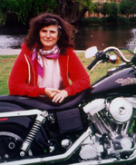 photo of the author, Barbara Joans , leaning against her Harley-Davidson Low Rider
