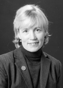 this is a photo of the author. Laurie Lawlor has light colored hair, and is wearing a dark blazer and turtleneck sweater. 