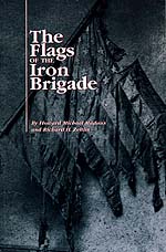 the cover of Flags of the Iron Brigade features a dark photo of a battle torn American flag.