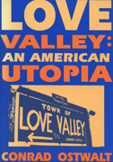 Book cover is dark blue and orange, with a "town of Love Valley" sign in the center of the cover.