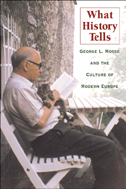 the cover of What History Tells is illustrated with a color photo of George Mosse reading a book, with a cat, on an outdoor bench.
