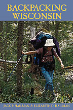 the cover of the Backpacking book shows a photo of a woman in a blue cap climbing a steep trail