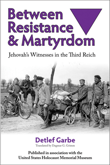 The cover of Garbe's book is white with purple type. The photo is of several men in striped concentration camp clothing hauling a small cart down a road as German guards watch on.