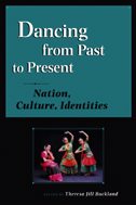 cover of Buckland book is illustrated with a photo of three women in ethnic costume, dancing. The rest of the cover is teal with a graphic element behind.