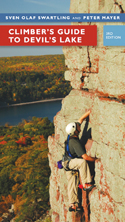 Climber's Guide to Devil's Lake: cover depicting a person climbing a sheer rock, beautiful, early autumn trees outlining the devil's lake shore below.