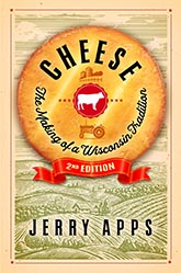 Cheese: Cover showing an aged cheese wheel containing the title text curved to match the curve of the cheese wheel. At the very center of the cheese wheel is a red and white cow icon, with a red, farm icon above it and a red, tractor icon below it. At the bottom of the cheese wheel is a red ribbon that says '2nd EDITION.' Behind the cheese wheel there is a manilla and green line drawing of rolling farmland.