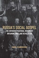 Russia's Social Gospel: cover displaying a grayscale photograph of a group of Russian priests sitting in three rows. The title text is proclaimed in yellow all caps text in the center of the page.