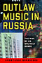 Outlaw Music in Russia: Cover depicting a collage of blurry images. The right side of the page has many dots of light speckling the photo. The title text is in bold, yellow text towards the top of the page, and the author text is contained in a red box at the bottom of the page.