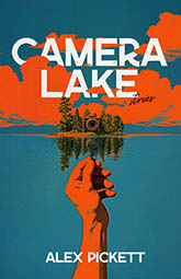 Camera Lake: cover depicting a small island full of trees and a giant camera. A hand stretches towards the island. The image is drawn in stark blue and orange, the subtlest hint of green in the trees. The title text is written in bold white font, partially obscured by the clouds over the island.