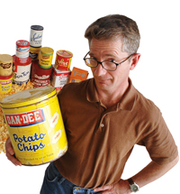 A photo of author Dirk Burhans with an armload of potato chip products.