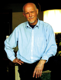 photo of author, Field, standing, wearing blue shirt and black pants.